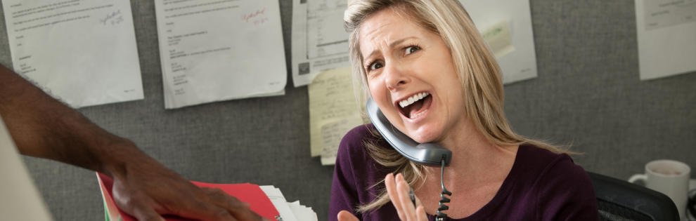 Woman office worker yells on a phone call